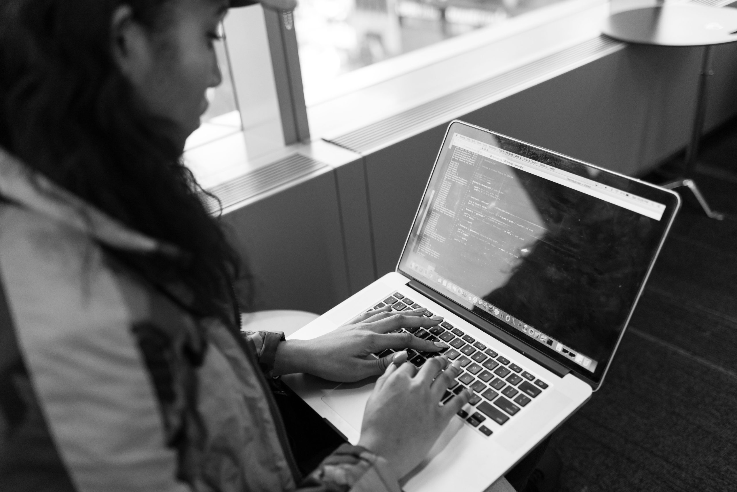 Femme tapant du code sur ordinateur portable moderne