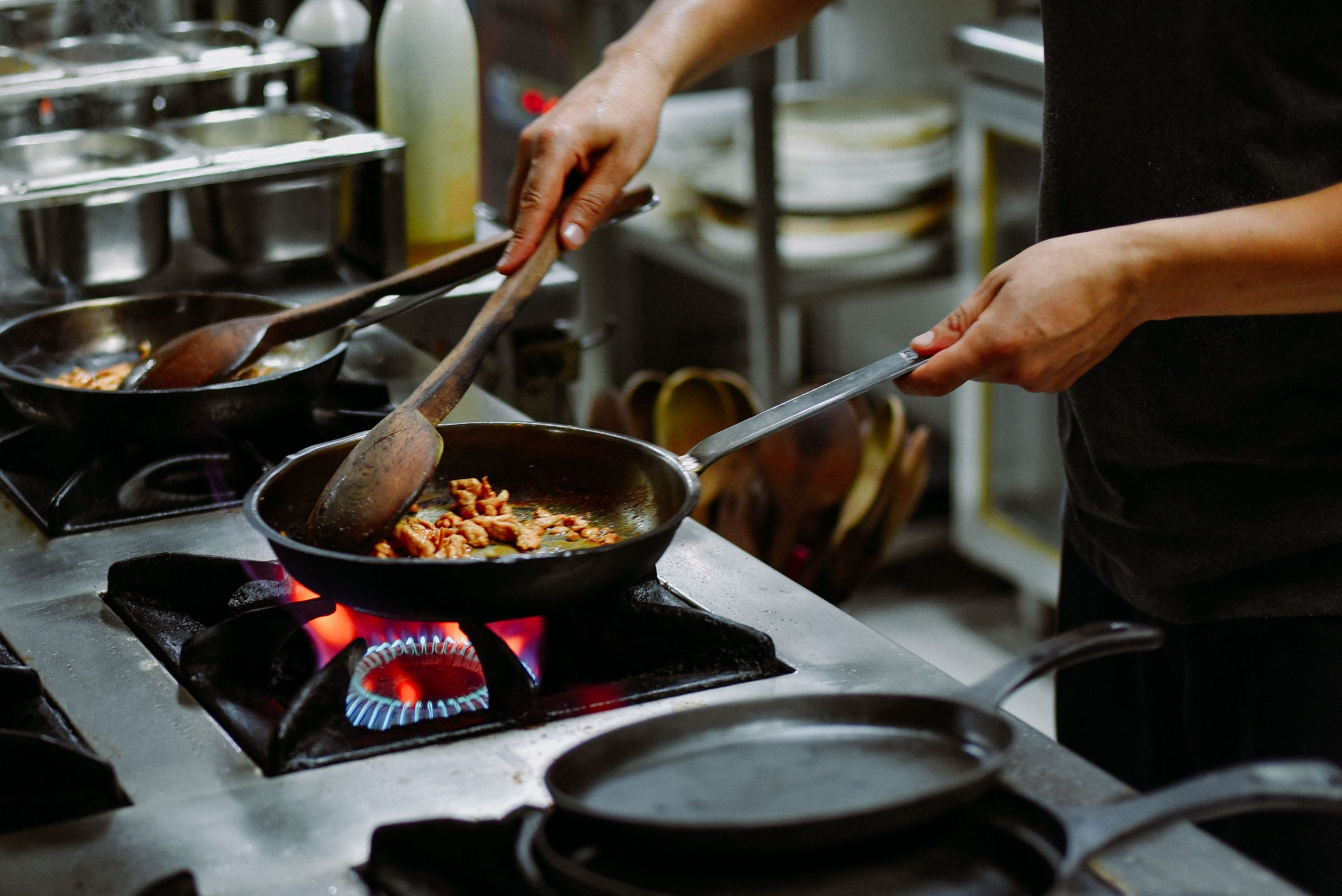 Chef préparant un plat avec ingrédients sautés